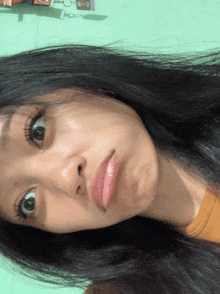 a close up of a woman 's face with long black hair