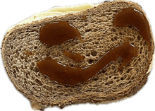 a slice of bread with a face drawn on it with syrup