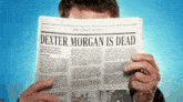 a man is reading a newspaper with the title dexter morgan is dead