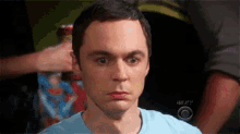 a close up of a man 's face with a cbs logo on the bottom right