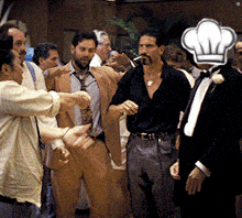 a man with a chef 's hat on his head is surrounded by other men