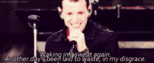 a man singing into a microphone with the words waking in a sweat again