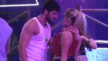 a man and a woman are standing next to each other in a room .