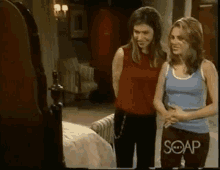 two women are standing next to each other in a room with soap written on the bottom of the screen