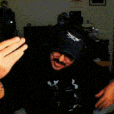 a man wearing a black hat that says ' supreme ' on it