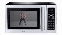 a man is dancing in a microwave with the time of 12:26
