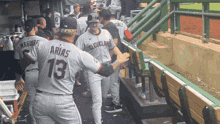 a baseball player with the number 13 on the back of his shirt