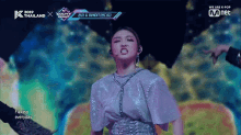 a woman performs on a stage with the words we are k pop on the bottom left