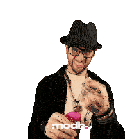a man wearing a hat and glasses is holding a pink glass with mcdh written on the bottom right