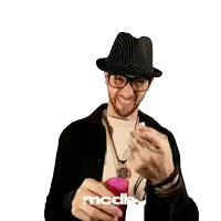 a man wearing a hat and glasses is holding a pink glass with mcdh written on the bottom right
