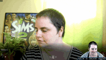 a woman is playing the sims 2 on a computer screen