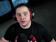 a man wearing headphones is making a funny face .