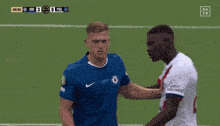 a soccer player with the number 1 on his jersey talks to another player