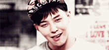 a close up of a young man wearing a baseball cap and smiling .