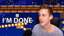 a man is sitting in front of a video game screen with the words `` i 'm done '' .