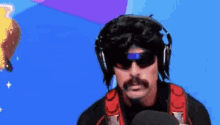 a man with a mustache and sunglasses is wearing headphones and a backpack .
