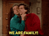 two men hugging each other with the words we are family in the background