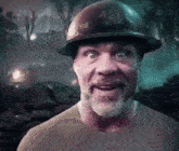 a man with a beard is wearing a helmet and making a face