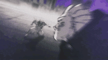 a blurry picture of a person 's face with a purple background that says tbs
