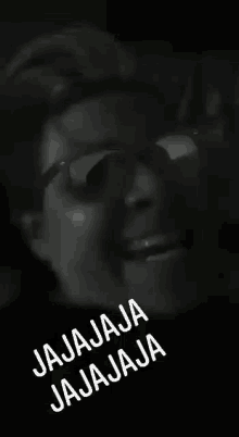 a black and white photo of a woman wearing glasses with the words jajaja jajaja on the bottom