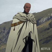 a man in a white cape is standing in front of a mountain and the word netflix is on the bottom