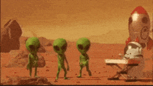 a group of green aliens dancing in the desert