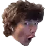 a close up of a person 's face with a surprised look on his face .