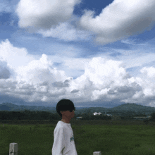 a person wearing sunglasses and a white shirt that says hawaii on it