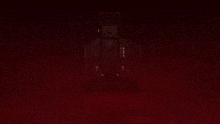 a person is hanging upside down in a dark room with a yellow light behind them .