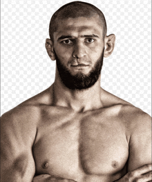 a man without a shirt has his arms crossed and looks at the camera