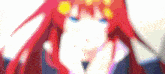 a blurry picture of a girl with red hair and blue eyes covering her face with her hands .
