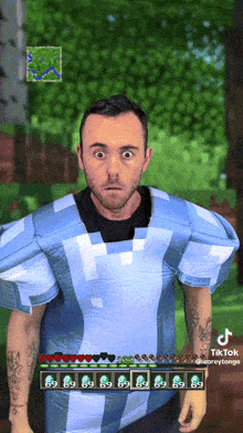 a man in a blue and white shirt is playing a video game