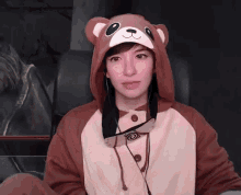 a woman wearing a teddy bear hooded jacket and hat