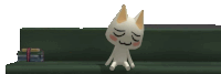 a white cat is sitting on a couch with its eyes closed
