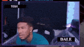 a man in a blue shirt is sitting in a chair with the name dale on the bottom right corner