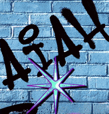 graffiti on a blue brick wall with a purple star in the center