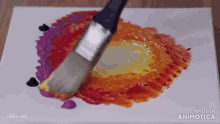 a brush is being used to paint a circle on a canvas .