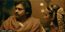 a man and a woman are standing next to each other with the words pranay varma on the bottom right