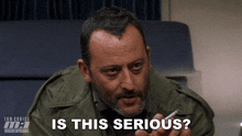 a man smoking a cigarette with the words " is this serious " next to him