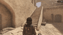 a screenshot of a video game shows a person walking down stairs