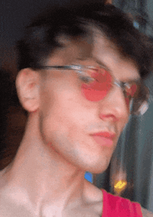 a man wearing red sunglasses and a red shirt