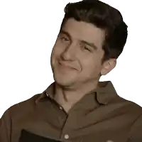 a man in a brown shirt is smiling and holding a book