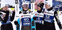 a group of skiers are posing for a picture and one of them has the number 40 on his shirt