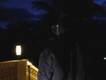 a person wearing a fur coat with a hood and a chain around their neck has the word hood on their head