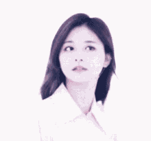 a woman with long purple hair is wearing a white shirt and looking to the side .