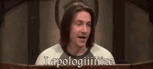 a man behind a podium with the words i apologize on it
