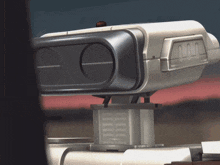 a close up of a futuristic device with the letter m on the side