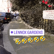 a sign that says lennox gardens is on the sidewalk