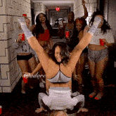 a woman is doing a handstand in a hallway with adore written on the bottom right corner
