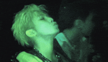 a close up of a person 's face with a green light shining on it